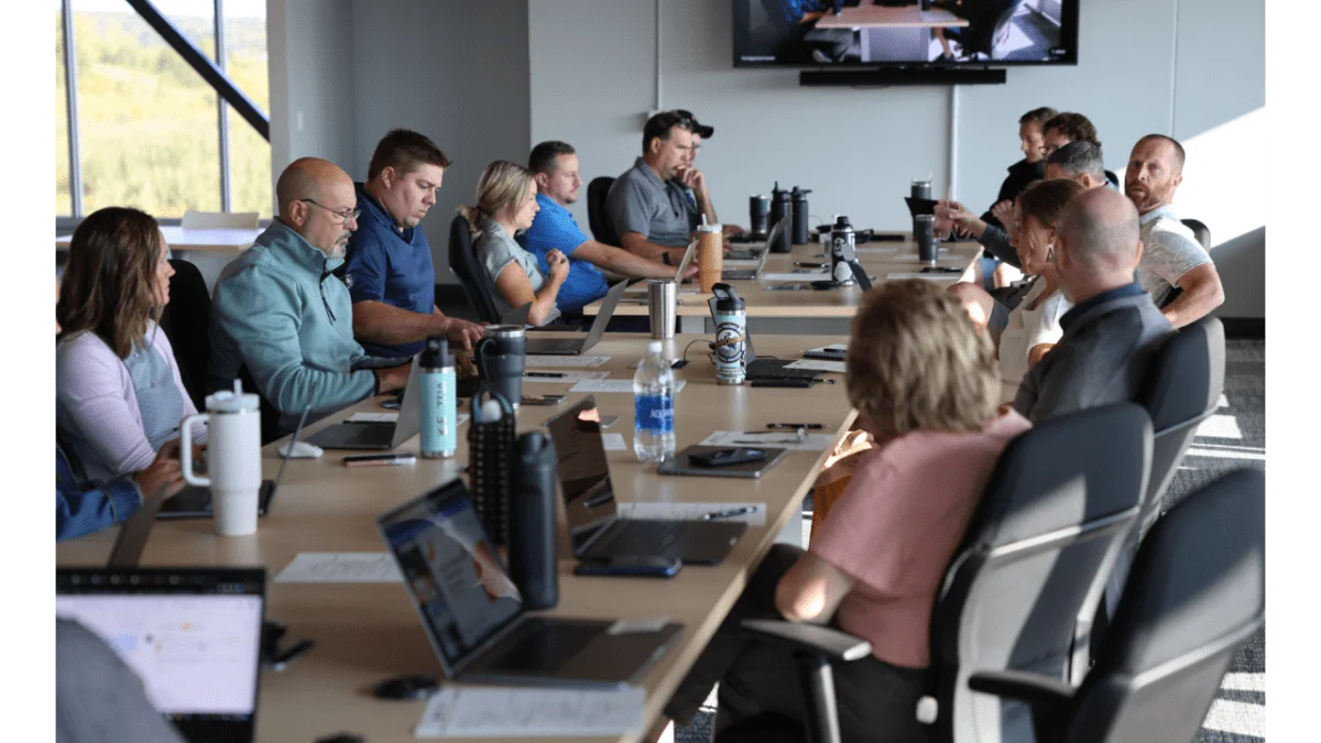 Image of the Elite EXTRA team meeting in a conference room during the 2023 company event
